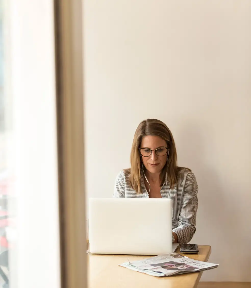 Photo of woman writing email on a laptop