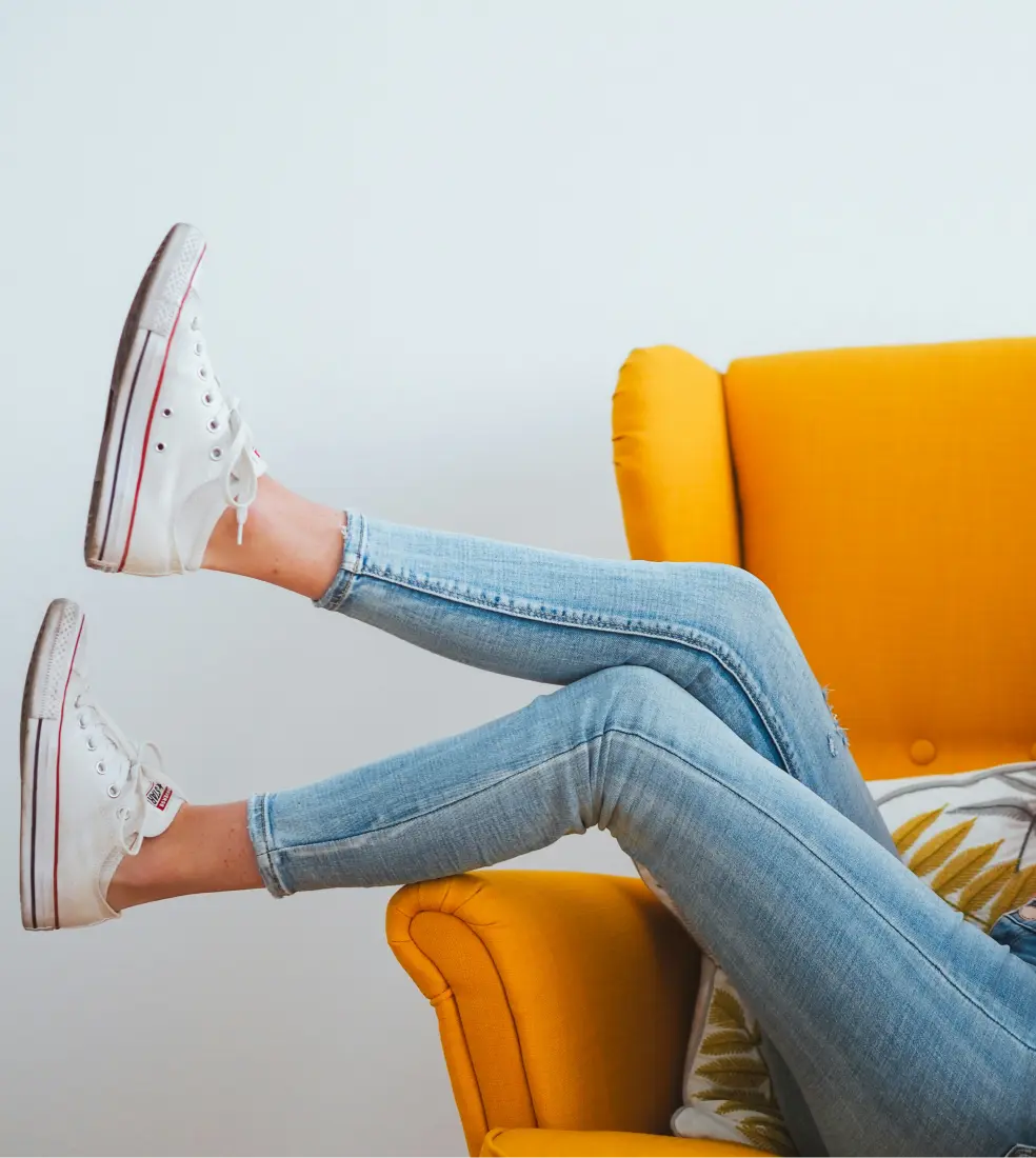 Photo of woman relaxing on yellow chair